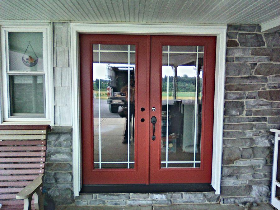 Double entry doors set in a stone and siding front